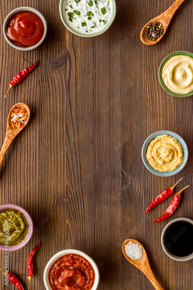 Set of sauces in bowls with spices in spoons and ingredients, top view Set of sauces in bowls with spices in spoons and ingredients, top view