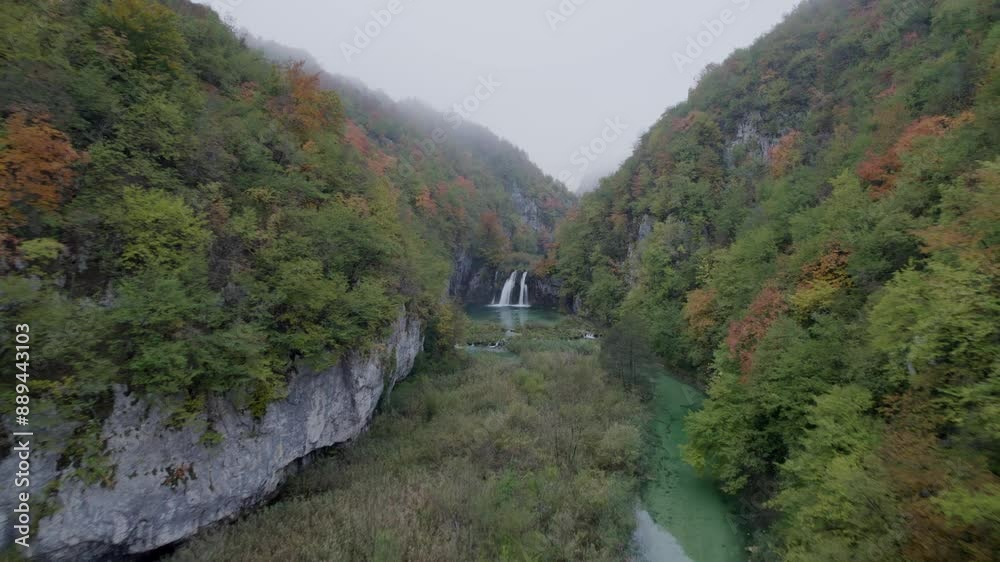 Aerial view of serene Plitvicka Lake with misty waterfall and lush forest, Lika-Senj, Croatia. Aerial view of serene Plitvicka Lake with misty waterfall and lush forest, Lika-Senj, Croatia.