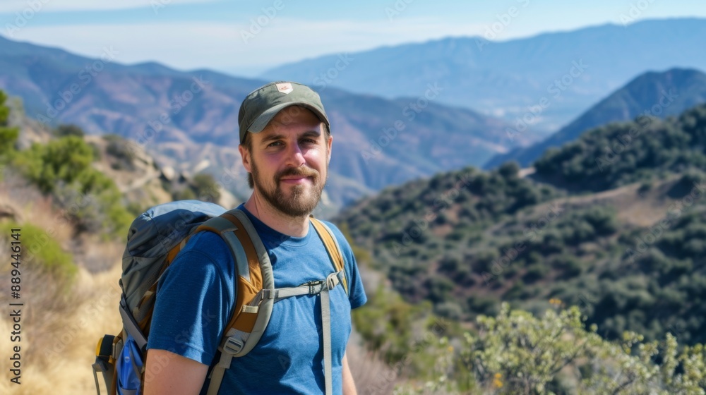 A portrait of a male hiker standing on a mountain trail A portrait of a male hiker standing on a mountain trail