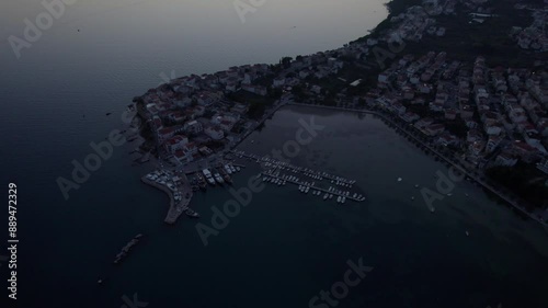 Aerial view of serene coastal town with tranquil harbor and calm sea, Stobrec, Split-Dalmatia, Croatia. photo