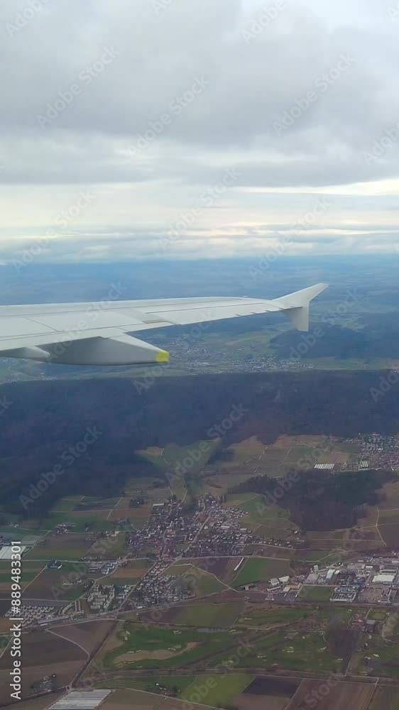 airplane wing view flying over countryside