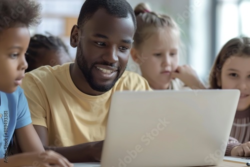 Teacher Teaching Diverse School Kids Using Laptop