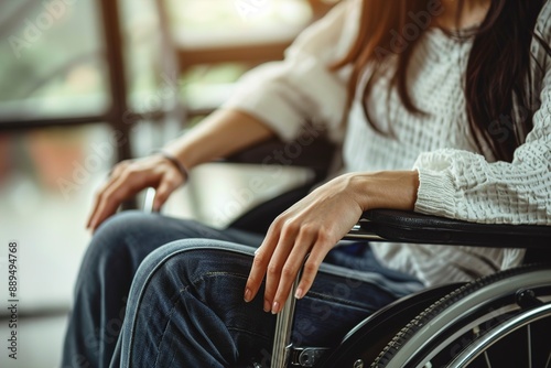 Woman in wheelchairs hand on wheel close up disability © Jorge Ferreiro