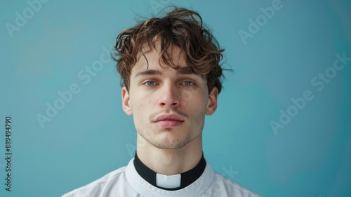 Wallpaper Mural Young priest on blue background Torontodigital.ca