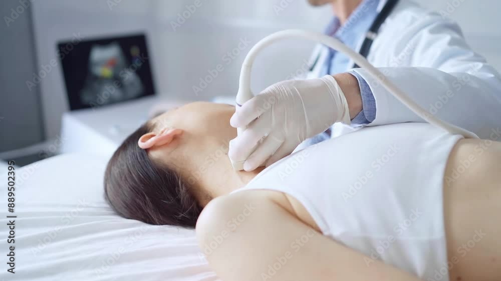 Doctor man is using ultrasound equipment on neck of female patient lying down for a medical examination. Medicine and science Doctor man is using ultrasound equipment on neck of female patient lying down for a medical examination. Medicine and science