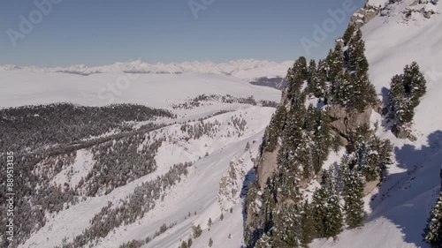 Aerial view of snowcapped mountain peaks and trees in Dolomites, South Tyrol, Italy. photo