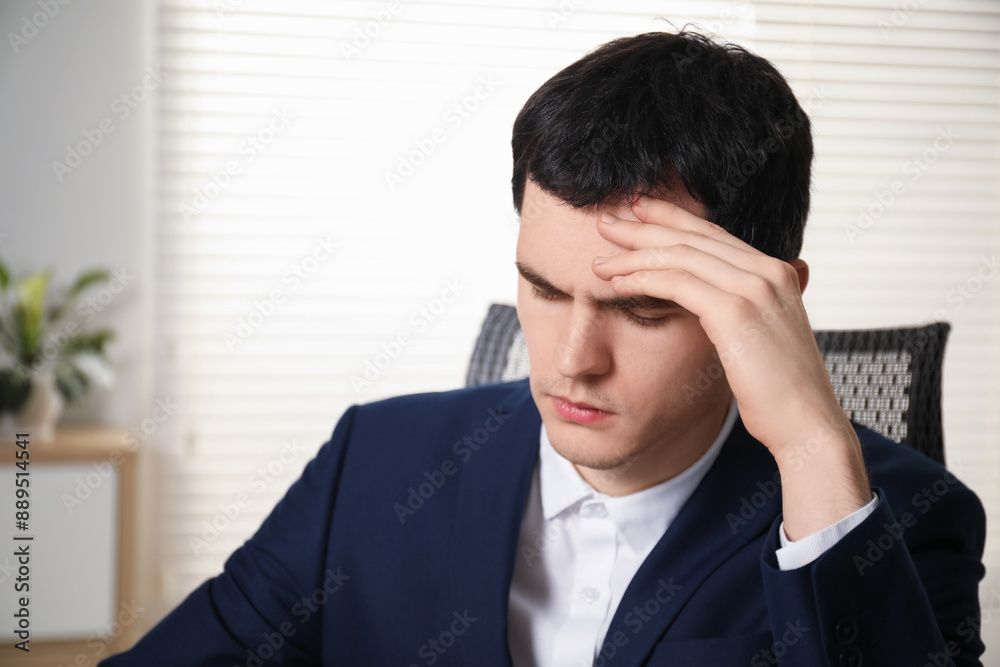 Portrait of embarrassed young man in office Portrait of embarrassed young man in office
