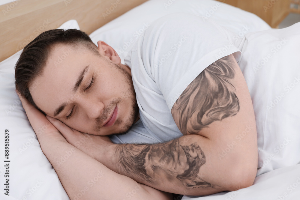Bedtime. Handsome man sleeping in bed indoors Bedtime. Handsome man sleeping in bed indoors