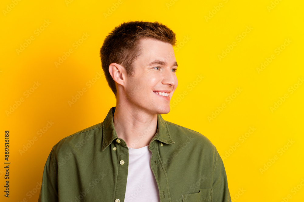 Photo of attractive nice cheerful man wear stylish khaki clothes look empty space isolated on vivid yellow color background Photo of attractive nice cheerful man wear stylish khaki clothes look empty space isolated on vivid yellow color background