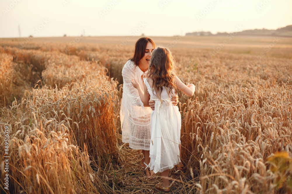 Mother with daughter playing in a summer field Mother with daughter playing in a summer field