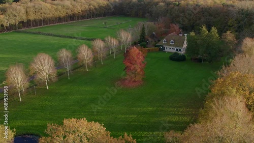 Aerial view of autumn sunset over house, forest, and road in Oudemirdum, Friesland, Netherlands. photo