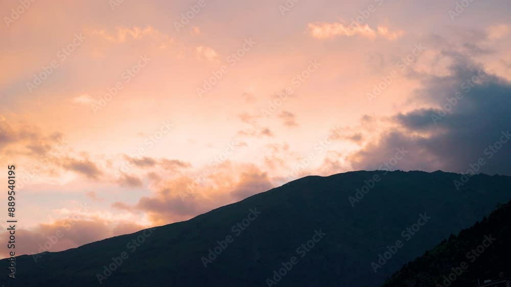 4K shot of orange clouds above the Himalayan mountain during the sunset as seen from Keylong in Lahaul, Himachal Pradesh, India. Orange clouds above the mountain peaks. Natural sunset background. 4K shot of orange clouds above the Himalayan mountain during the sunset as seen from Keylong in Lahaul, Himachal Pradesh, India. Orange clouds above the mountain peaks. Natural sunset background.