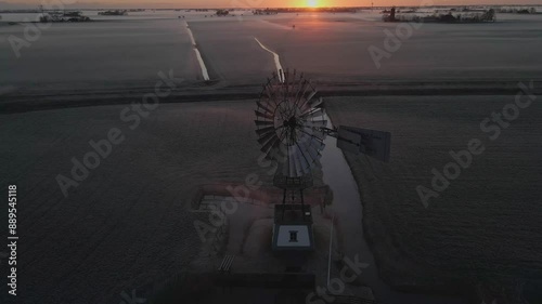 Aerial view of serene countryside with old windmill, fog, and meadow at sunrise, Lytsewierrum, Friesland, Netherlands. photo