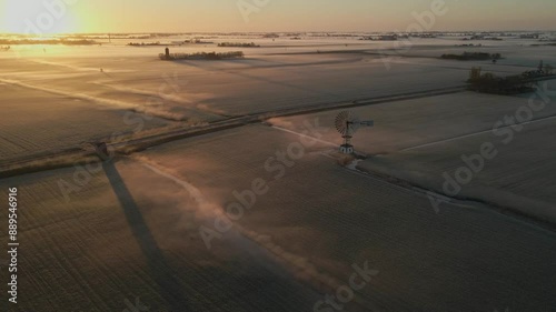 Aerial view of foggy sunrise over meadow with old windmill in Lytsewierrum, Friesland, Netherlands. photo