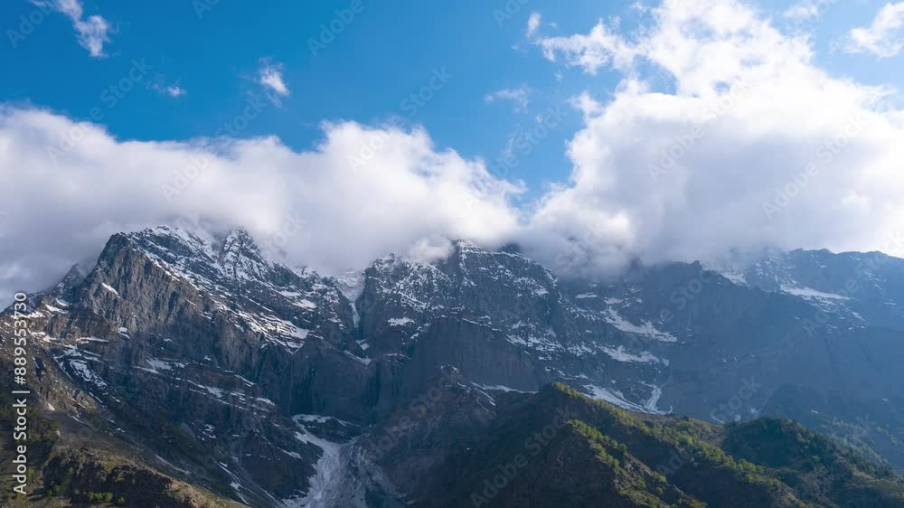 4K Wide angle Time-lapse shot of clouds rolling above the snowy Himalayas as seen from Khangsar Village in Lahaul, Himachal Pradesh, India. Clouds cover the mountain peaks and roll around them. 4K Wide angle Time-lapse shot of clouds rolling above the snowy Himalayas as seen from Khangsar Village in Lahaul, Himachal Pradesh, India. Clouds cover the mountain peaks and roll around them.