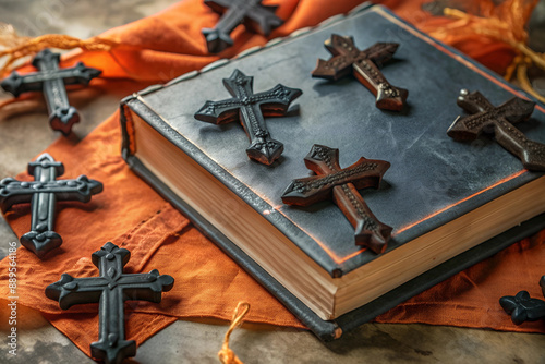 Black crosses and bibles as Halloween decorations on the table. Leave space for text,