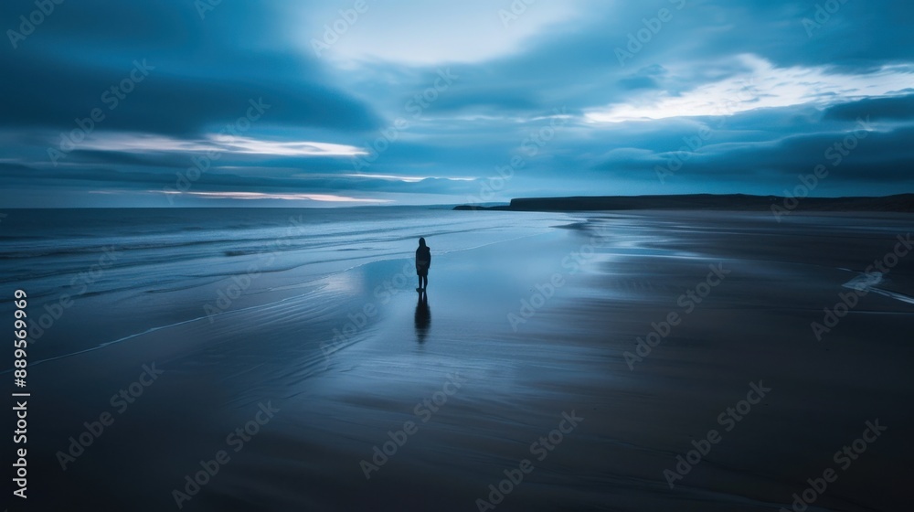 Melancholy induced solitary figure on empty beach with long exposure seascape, with copy scape Melancholy induced solitary figure on empty beach with long exposure seascape, with copy scape
