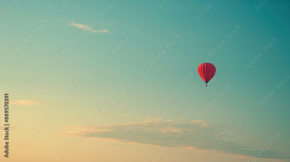 Obraz premium Solitary hot air balloon in vast sky during early morning light, with copy space