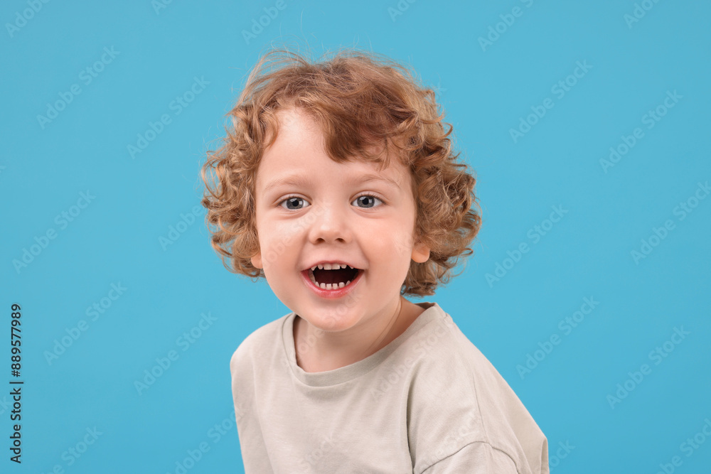 Portrait of cute little boy on light blue background Portrait of cute little boy on light blue background