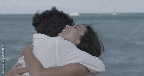 Young couple hugging laughing happily