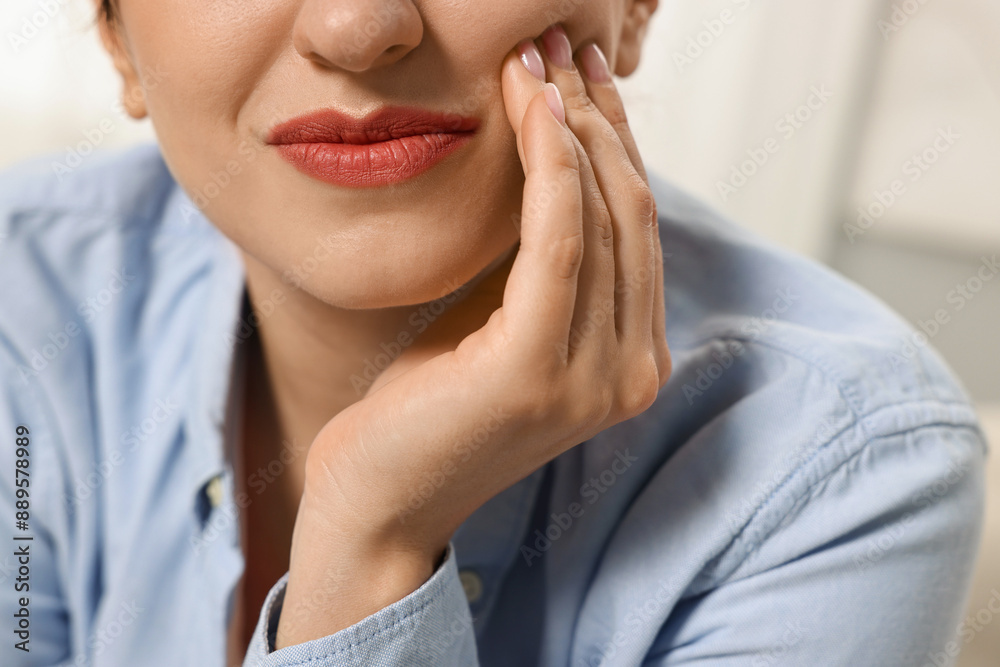 Woman suffering from toothache indoors, closeup view Woman suffering from toothache indoors, closeup view