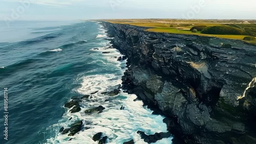 Drone footage of a stretch of coastline with noticeable erosion patterns highlighting the contrast between eroded and untouched areas.