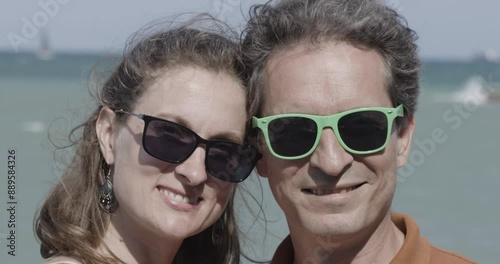 Smiling couple by the sea. Close-up portrait.
