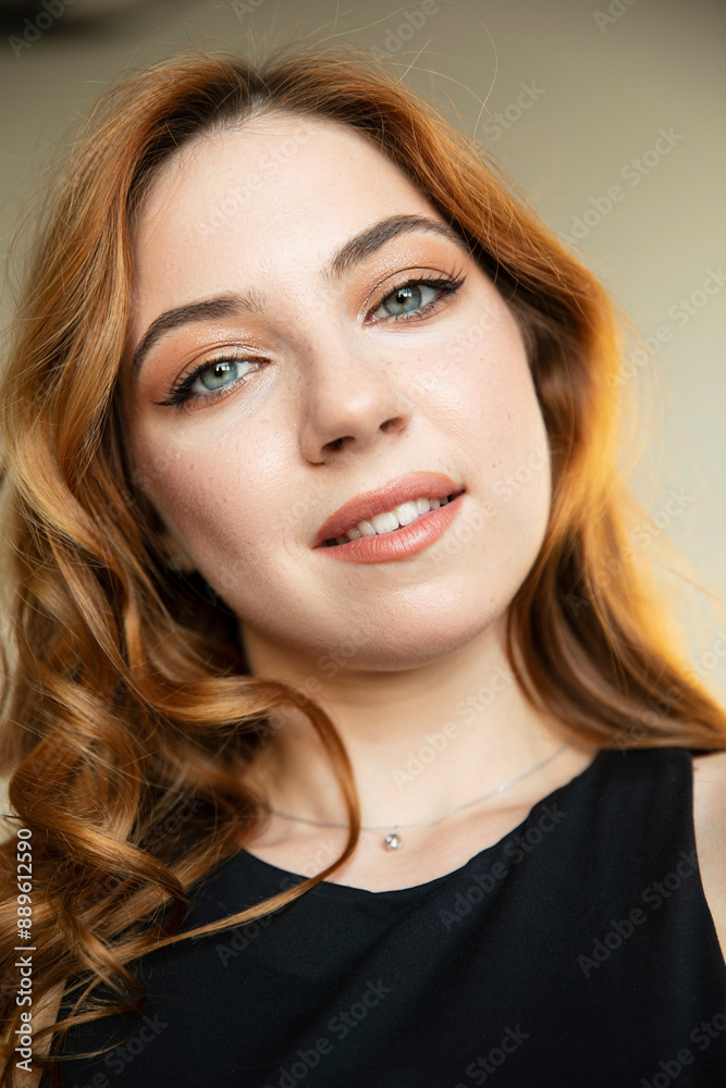 Closeup portrait of young curly red-haired elegant woman, with makeup, looking at camera. Closeup portrait of young curly red-haired elegant woman, with makeup, looking at camera.