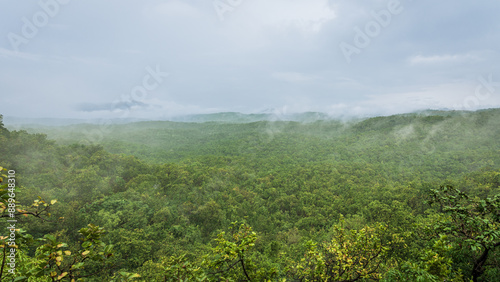 Panoramic view of Pachmarhi valley having clouds and mist shrouded hills rolling on each other from vantage point Green Valley view point in Pachmarchi, Madhya Pradesh, India. photo