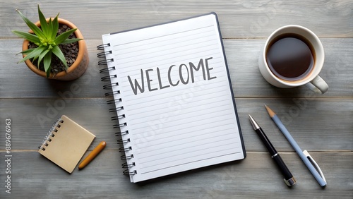 Notebook with word Welcome on grey table. Office desk with stationery and coffee, flat lay photo