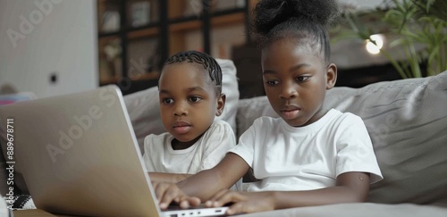 Two Children Watching Laptop on Couch in Living Room
