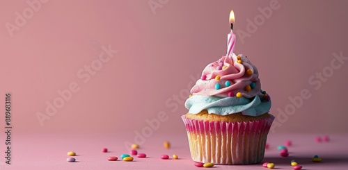 Single Birthday Cupcake With Candle and Sprinkles on Pink Background