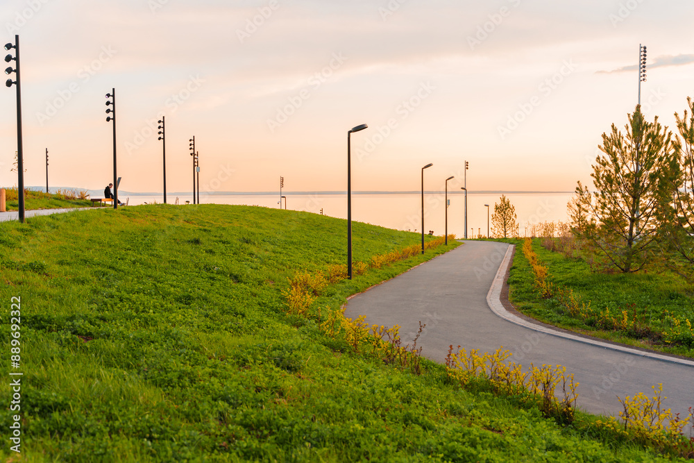 Beautiful sunset light on the paths in the city park. Beautiful sunset light on the paths in the city park.