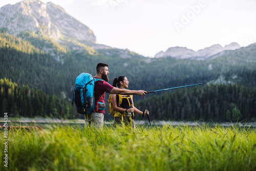 Couple Hiking in Mountains, Pointing Ahead