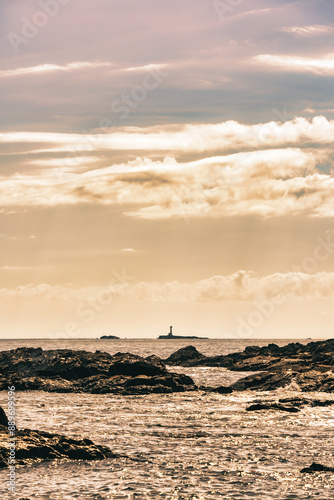 Scenic landscape at sunset with Ohira rock Lighthouse on the Pacific Ocean coast in Nachikatsuura, Wakayama, Japan. photo