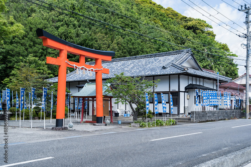A shinto temple and Torii gate shrine in Katsuura, Nachikatsuura, Higashimuro District, Wakayama , Japan. English transl. from the blue flags: Eightfold Way.