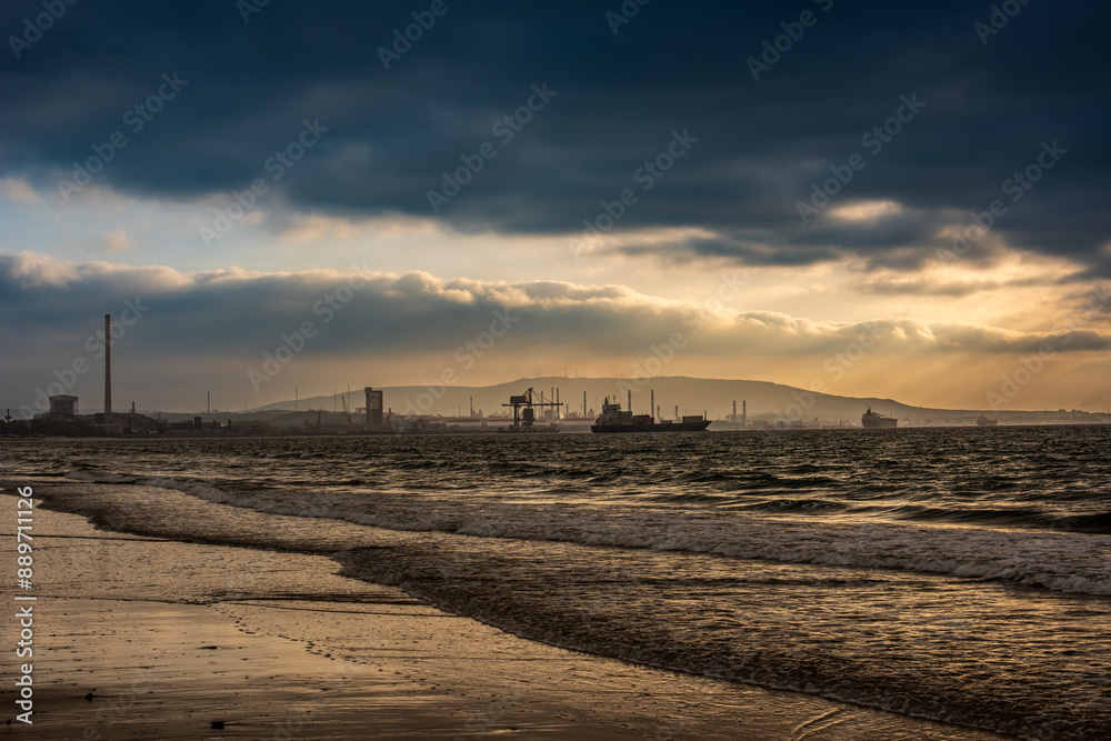 El Rinconcillo Beach at Dusk with Industrial Background in Algeciras, Spain El Rinconcillo Beach at Dusk with Industrial Background in Algeciras, Spain