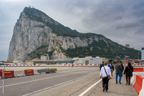 People Walking Across Airport Runway in Gibraltar, UK