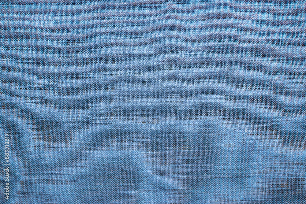 Texture of blue linen fabric closeup as textile background Texture of blue linen fabric closeup as textile background