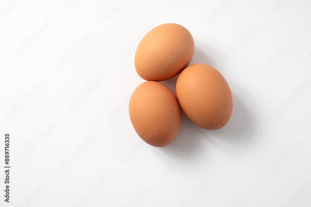 Top View of Three Brown Eggs on a White Background with Copy Space Top View of Three Brown Eggs on a White Background with Copy Space