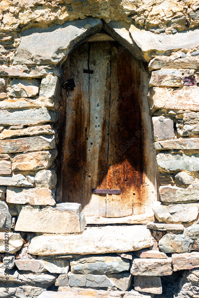 Closed old wooden shutters in a stone house high in the mountains Closed old wooden shutters in a stone house high in the mountains