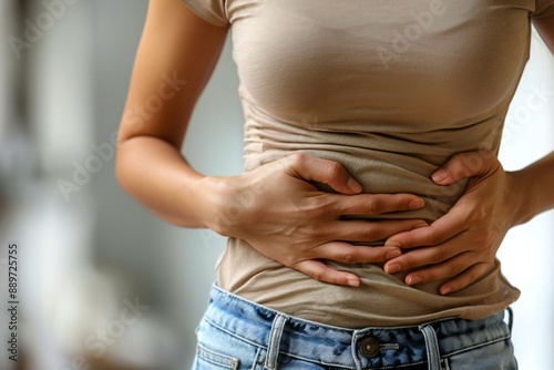 Young woman holding her stomach in pain, isolated on a transparent background to convey the theme of gut health, digestion problems, and medical issues like constipation, bloating