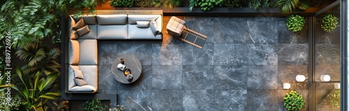 A Top View of a Secluded Patio With a Grey Sofa and Lush Greenery