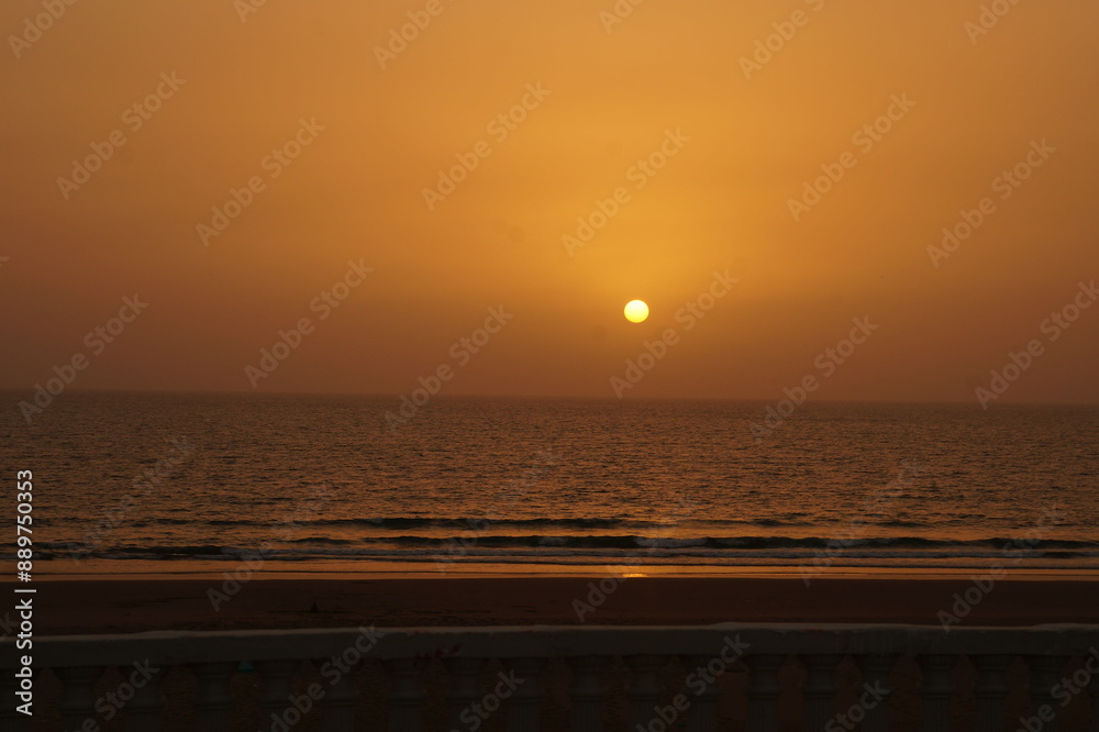 sunset at the beach. orange sky due to sun setting.