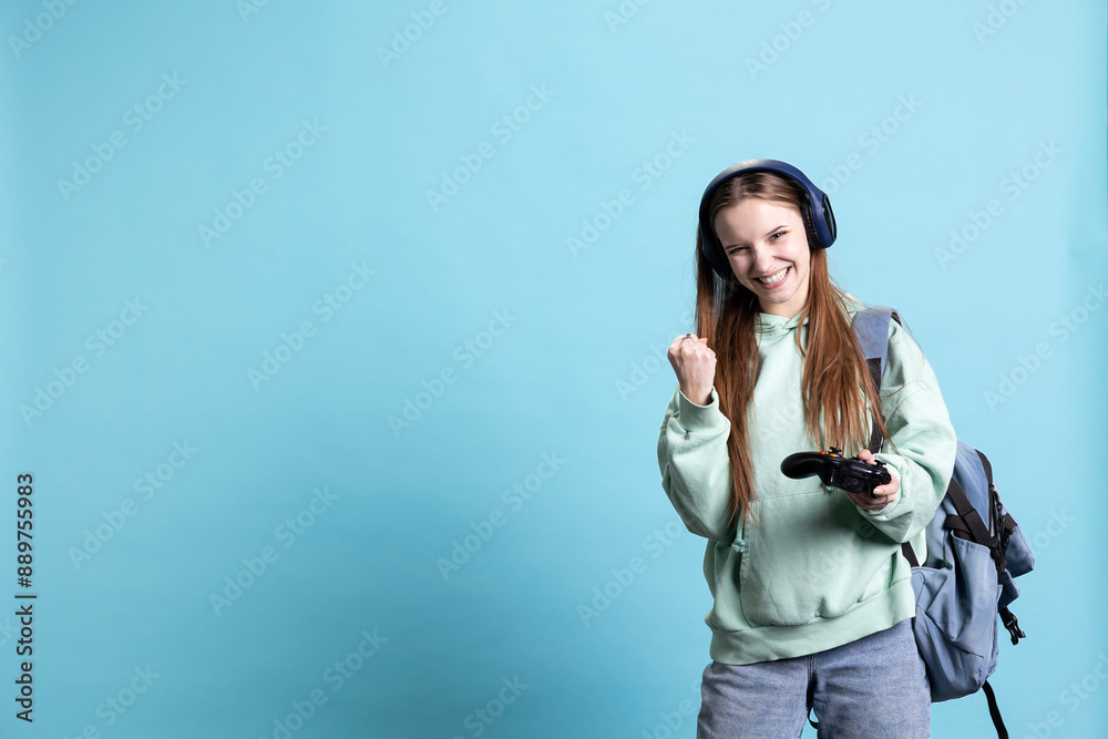 Euphoric woman playing intense gaming console game, celebrating win, isolated over studio background. Ecstatic young girl using controller, excited after being victorious in videogame Euphoric woman playing intense gaming console game, celebrating win, isolated over studio background. Ecstatic young girl using controller, excited after being victorious in videogame