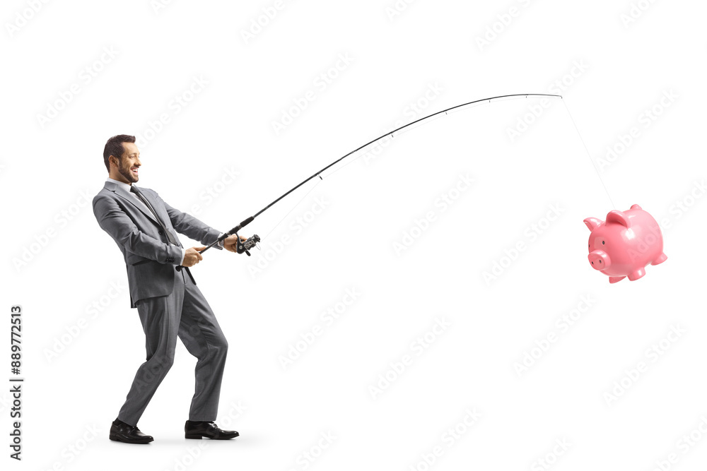 Obraz premium Businessman catching a piggy bank with a fishing rod