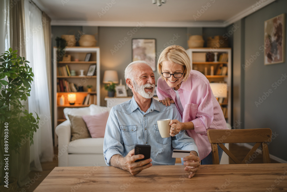 Senior couple buy online whit credit card on mobile phone at home Senior couple buy online whit credit card on mobile phone at home