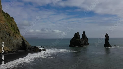 Aerial Drone footage of Reynisfjara Beach and the volcanic black sand and basalt structures in Iceland