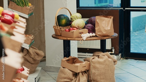 Natural fruits and vegetables displayed in crates on store shelves. Freshly harvested additives free merchandise to support vegan and healthy lifestyle, nonpolluting local farmers market. photo