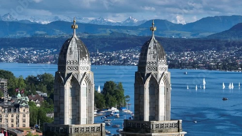 Two towers of Magnificent Grossmunster Cathedral in Zurich close-up, Shot tele lens shot, Alps Mountains on background
